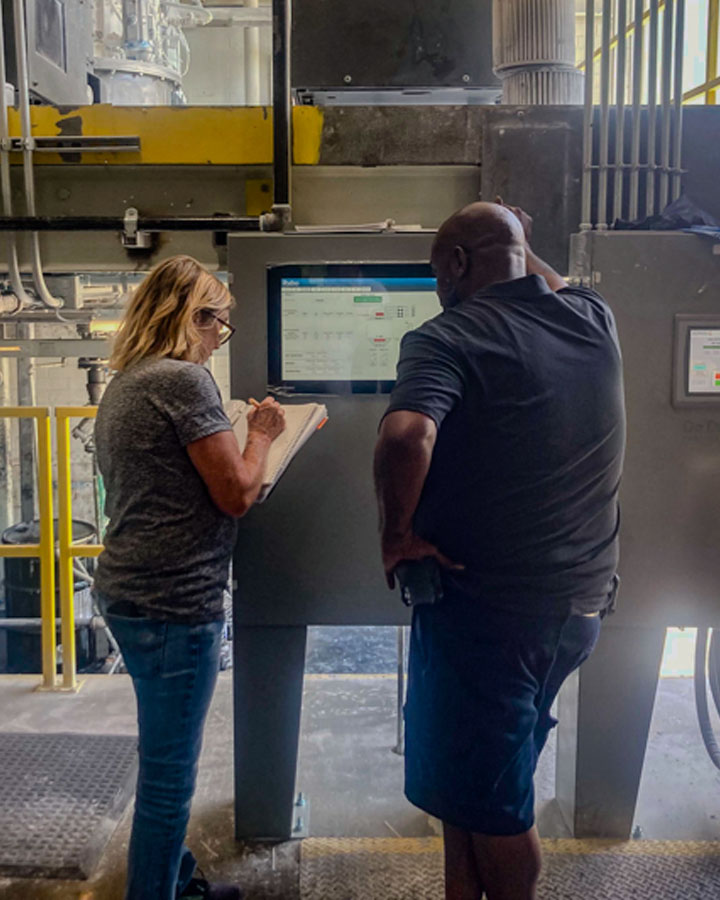 Workers setting the recipe on an ignition SCADA system